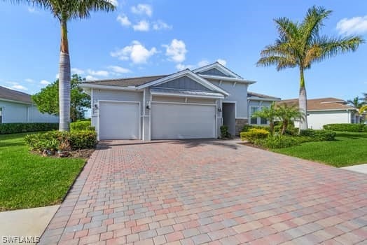 view of front of house with a front yard and a garage