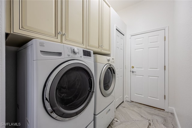 washroom with cabinets and washing machine and dryer