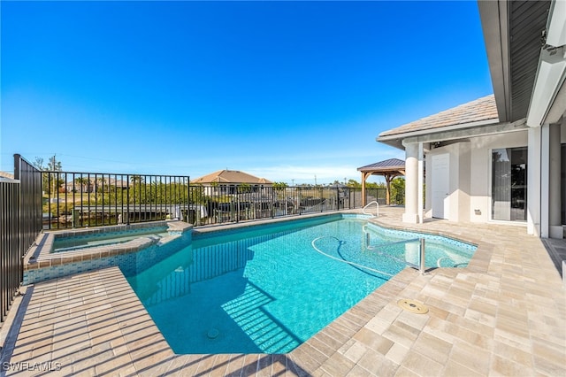 view of pool featuring a gazebo, a patio area, and an in ground hot tub