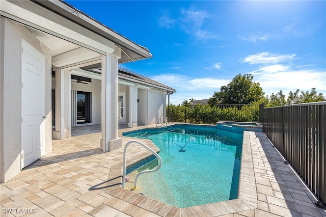 view of pool with an in ground hot tub and a patio