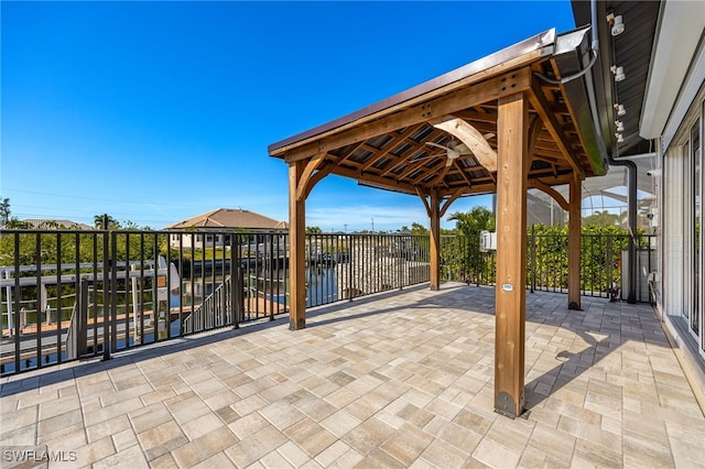 view of patio / terrace with a gazebo and a water view