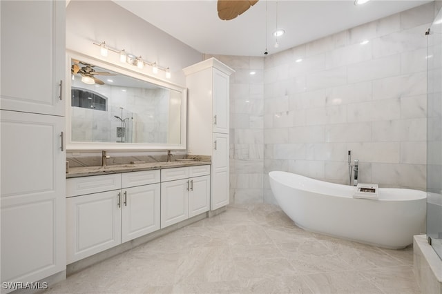 bathroom featuring ceiling fan, shower with separate bathtub, tile walls, and vanity