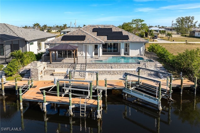 back of property featuring a gazebo, a water view, and a patio