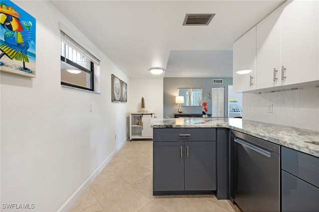 kitchen with tasteful backsplash, stainless steel dishwasher, light stone counters, gray cabinets, and white cabinetry