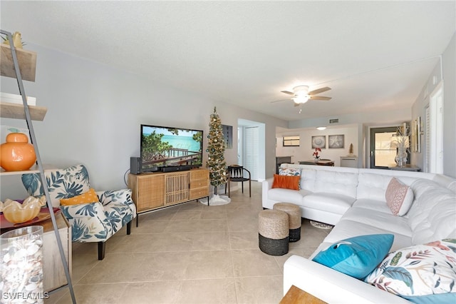 living room with ceiling fan and light tile patterned floors