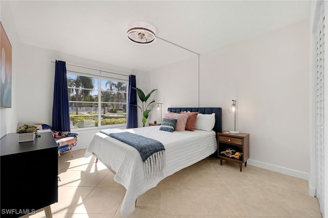 bedroom with light tile patterned floors