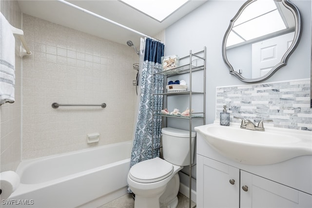 full bathroom with tasteful backsplash, vanity, shower / bath combo with shower curtain, tile patterned flooring, and toilet