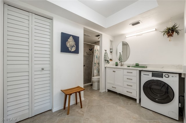 bathroom with vanity, a shower with shower curtain, tile patterned flooring, toilet, and washer / dryer