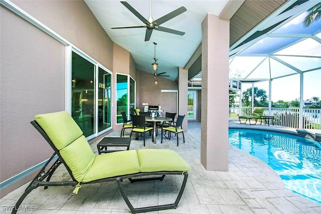 view of pool with ceiling fan, a patio area, and a lanai