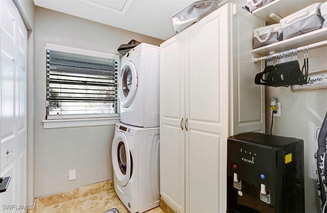 clothes washing area with stacked washer / dryer