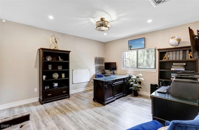 office area with light hardwood / wood-style floors