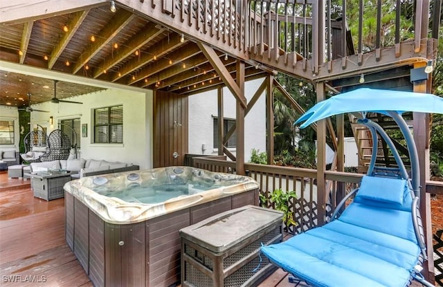 wooden deck with a hot tub