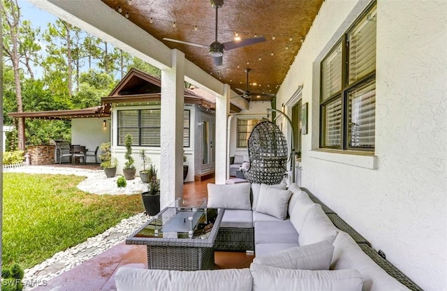 view of patio / terrace featuring ceiling fan and an outdoor living space