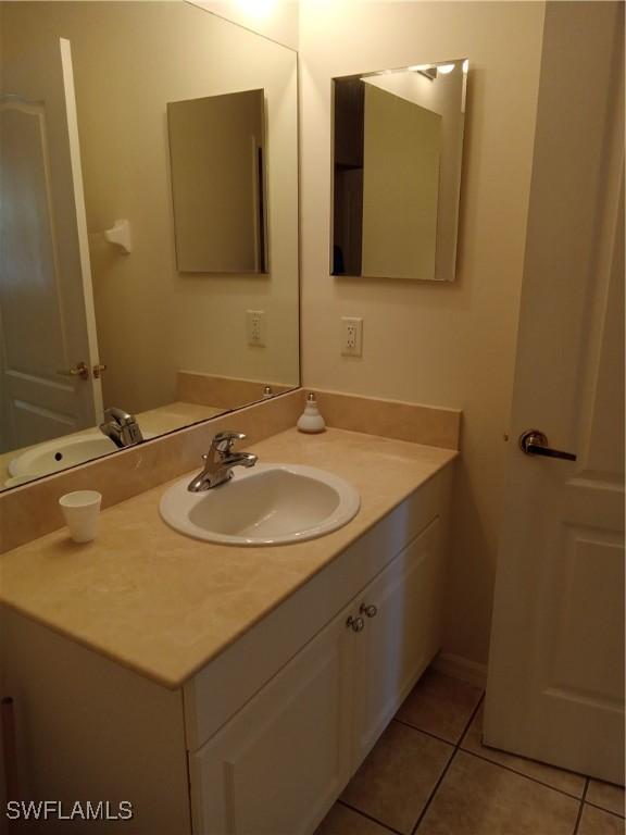 bathroom featuring tile patterned flooring and vanity