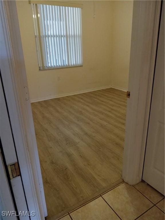 interior space featuring wood finished floors and baseboards