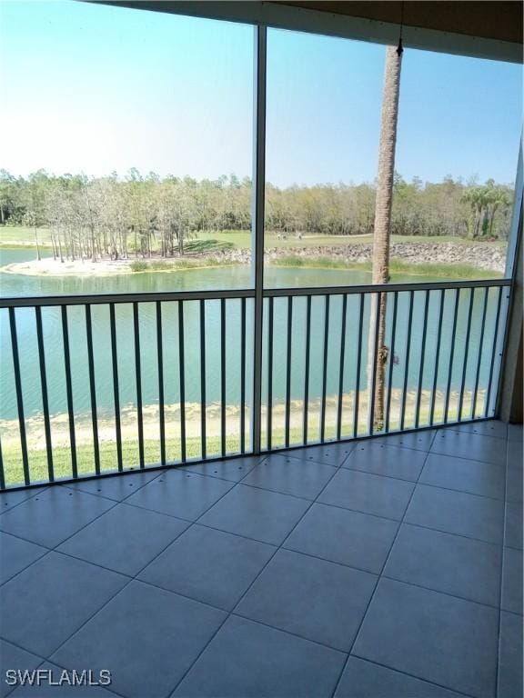 unfurnished sunroom with a healthy amount of sunlight and a water view