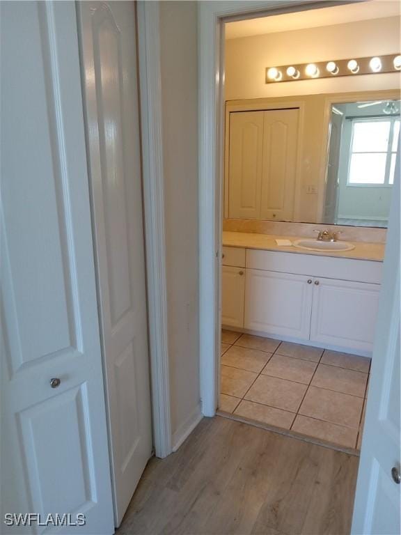 bathroom with vanity and wood finished floors