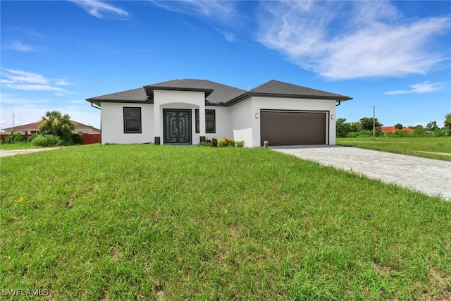 prairie-style home with a front lawn and a garage