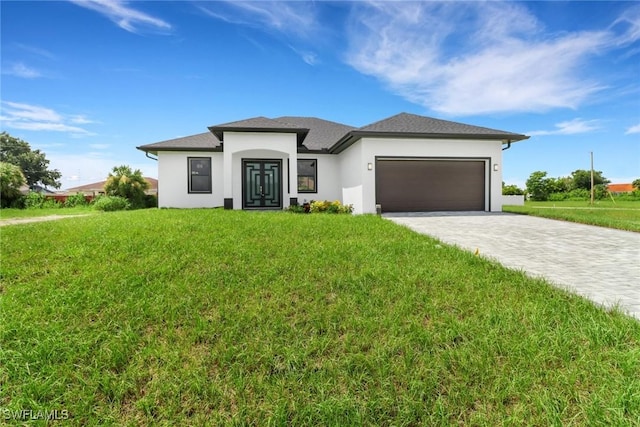 view of front of house featuring a garage and a front lawn