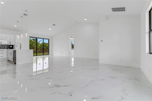 empty room featuring lofted ceiling