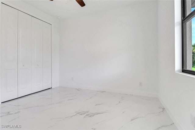 unfurnished bedroom with a closet and ceiling fan