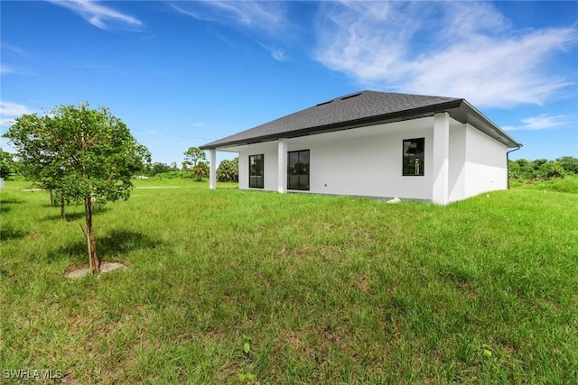 rear view of property with a lawn