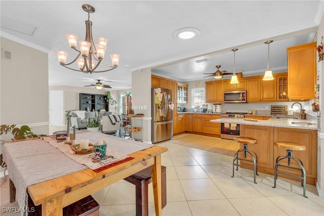 kitchen with stainless steel appliances, light tile patterned flooring, glass insert cabinets, and crown molding