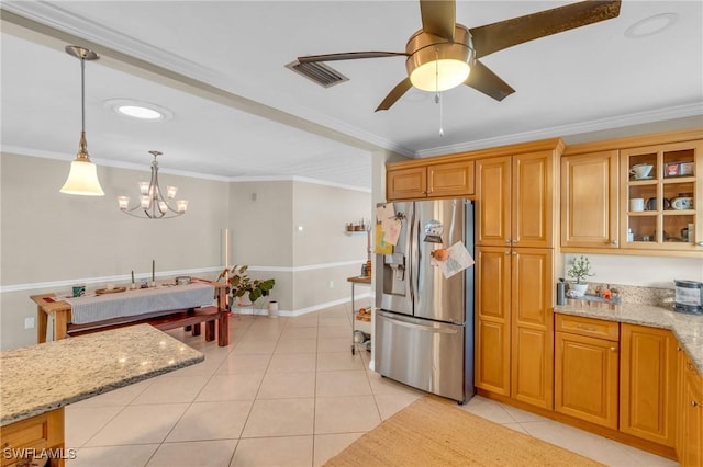 kitchen with light stone countertops, light tile patterned floors, crown molding, and stainless steel fridge with ice dispenser