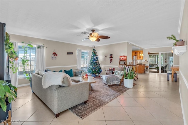 living room featuring ornamental molding, ceiling fan, and light tile patterned floors