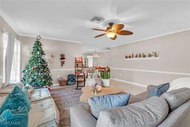 living area featuring ornamental molding, ceiling fan with notable chandelier, visible vents, and tile patterned floors