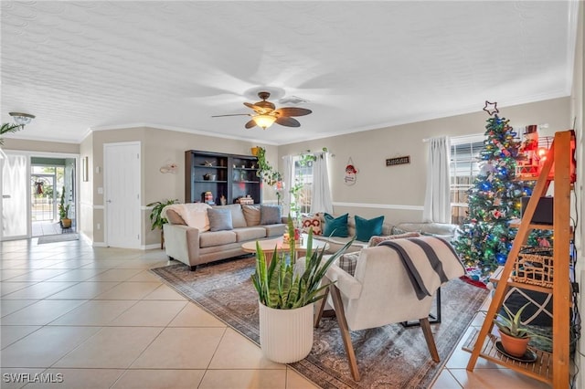 living area with light tile patterned floors, ornamental molding, and a wealth of natural light