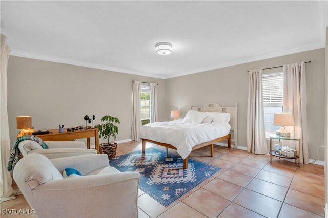 bedroom featuring ornamental molding, baseboards, and light tile patterned floors