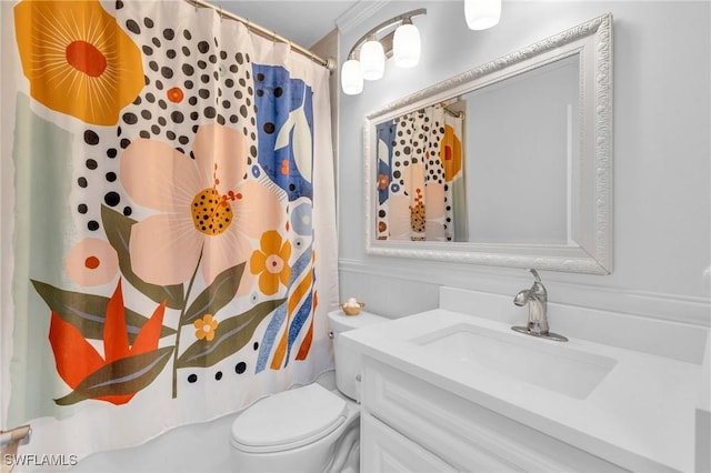 bathroom featuring toilet, vanity, and a shower with curtain