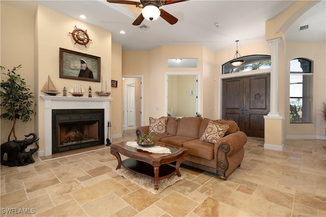 living room with ornate columns and ceiling fan