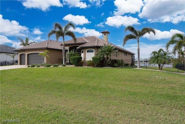 mediterranean / spanish-style home with a front yard and a garage