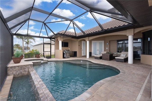 view of swimming pool with french doors, a lanai, an in ground hot tub, exterior kitchen, and a patio