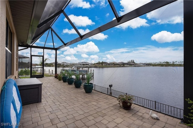 view of patio / terrace with a water view, a dock, and a lanai