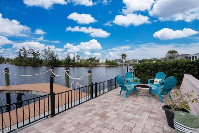 view of patio featuring a water view and an outdoor fire pit