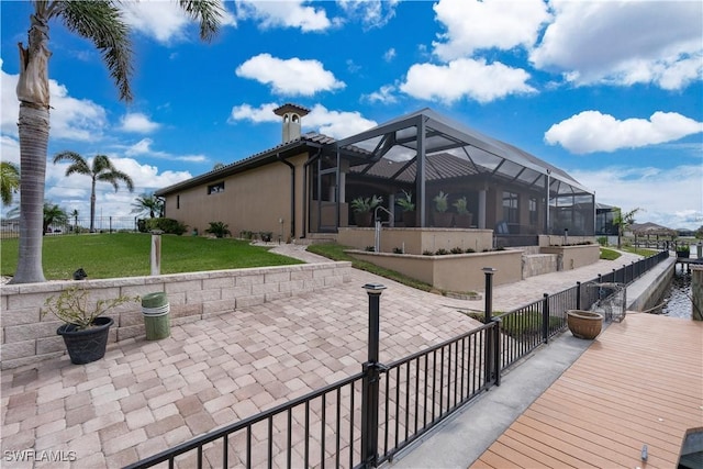 view of patio with glass enclosure