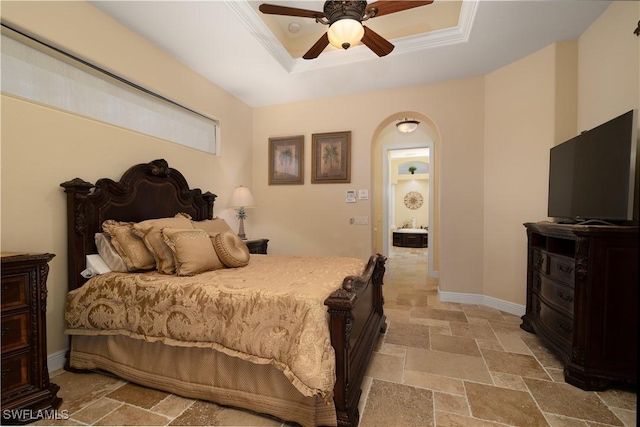 bedroom featuring a raised ceiling, ceiling fan, and ornamental molding