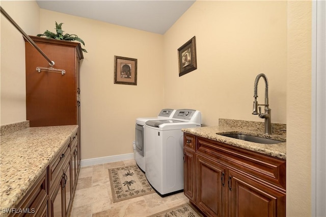 laundry area with sink, cabinets, and independent washer and dryer