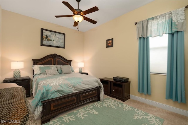 bedroom with ceiling fan and light carpet