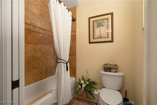 bathroom with shower / bath combo and toilet