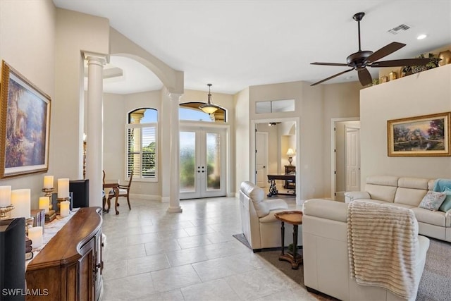 living room featuring ornate columns, ceiling fan, french doors, and light tile patterned flooring