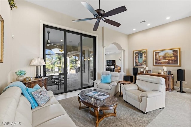 living room featuring ceiling fan and french doors