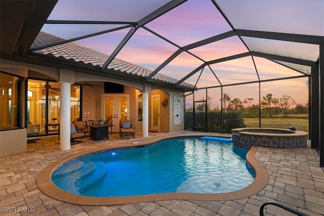 view of pool featuring ceiling fan, french doors, a lanai, an in ground hot tub, and a patio