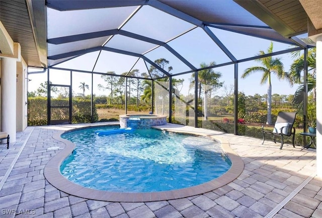 view of swimming pool with glass enclosure, an in ground hot tub, and a patio