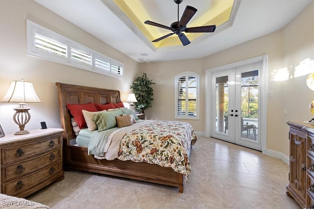 bedroom featuring french doors, access to outside, ceiling fan, and a tray ceiling