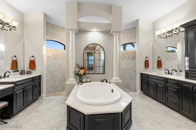 bathroom with a bathing tub, plenty of natural light, and vanity