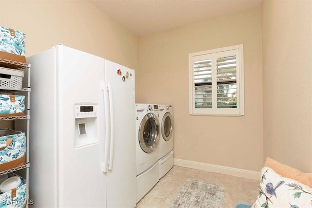 clothes washing area featuring separate washer and dryer